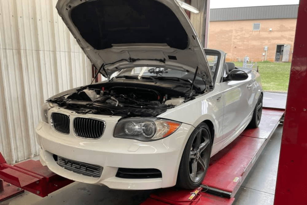 Pre-trip inspections, auto repair in Greer, SC by Eastside Automotive. Image of a white BMW convertible on a lift with the hood open for service. Highlighting Eastside Automotive’s commitment to precise European diagnostics and dependable performance.